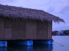 A house, floating on the sea on big floats